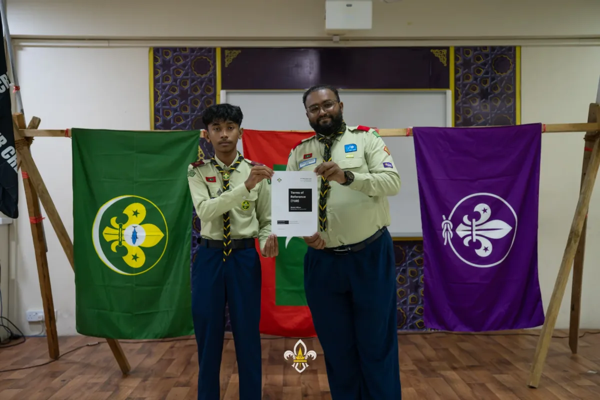 An EXCO officer and the Rover Advisor pose with the signed Terms of Reference.