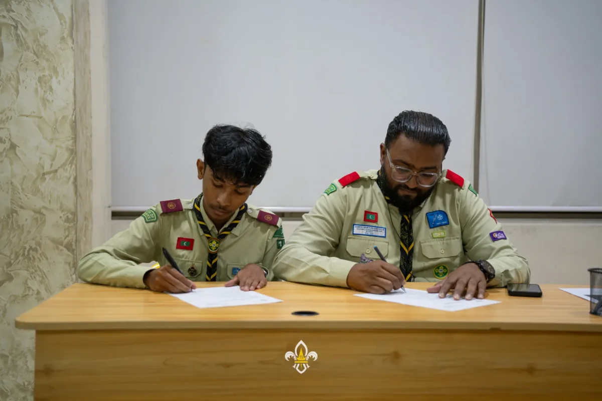 A new EXCO officer signs his Terms of Reference alongside the Rover Advisor.