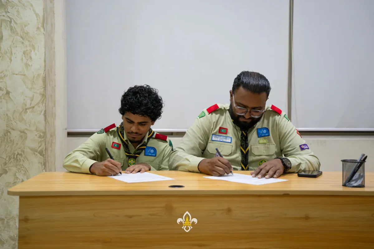 The second new EXCO officer signs his Terms of Reference alongside the Rover Advisor.