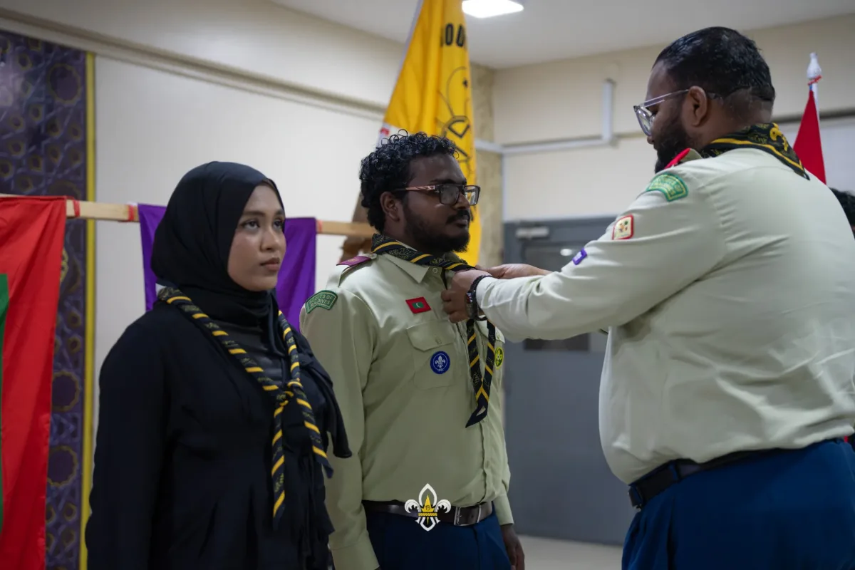 The Rover Advisor adjusts a newly invested Rover’s scarf during the presentation.