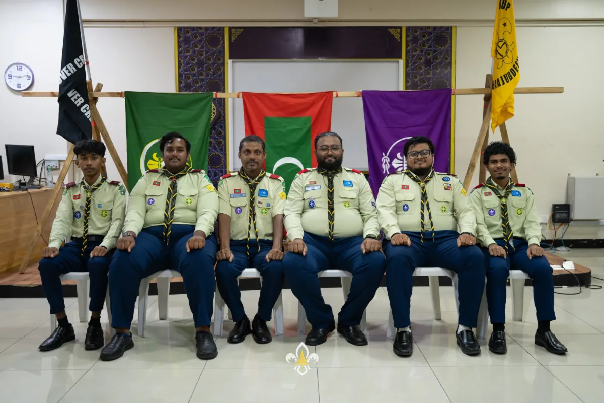 Seven crew members sit together for a group photograph following the ceremony.