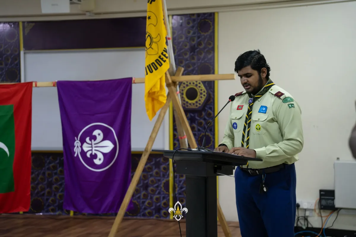 A Rover recites the Holy Qur’an at the lectern during the opening of the ceremony.