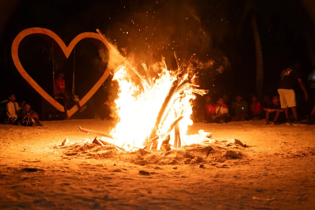 Scouts gathered around the campfire in the evening