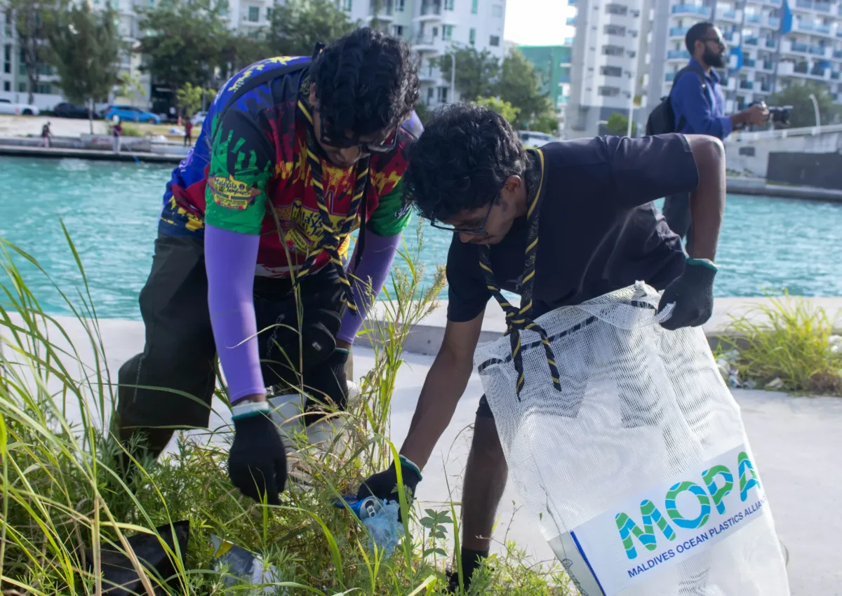 Two Rovers collecting litter from grassy vegetation along the Hulhumalé Phase 2 waterfront.